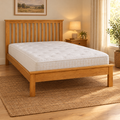 OakRidge Wooden Bed Frame in natural oak with a mattress, in a cosy bedroom